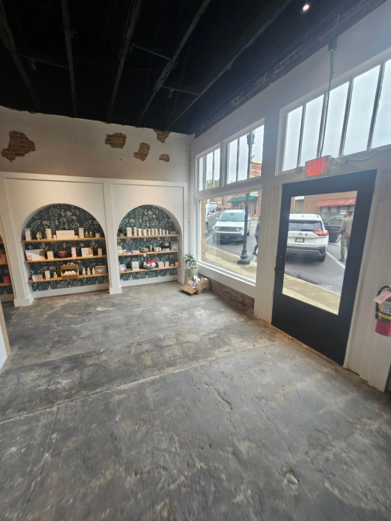 Completed spa entry with product shelving, a front window, and a concrete floor