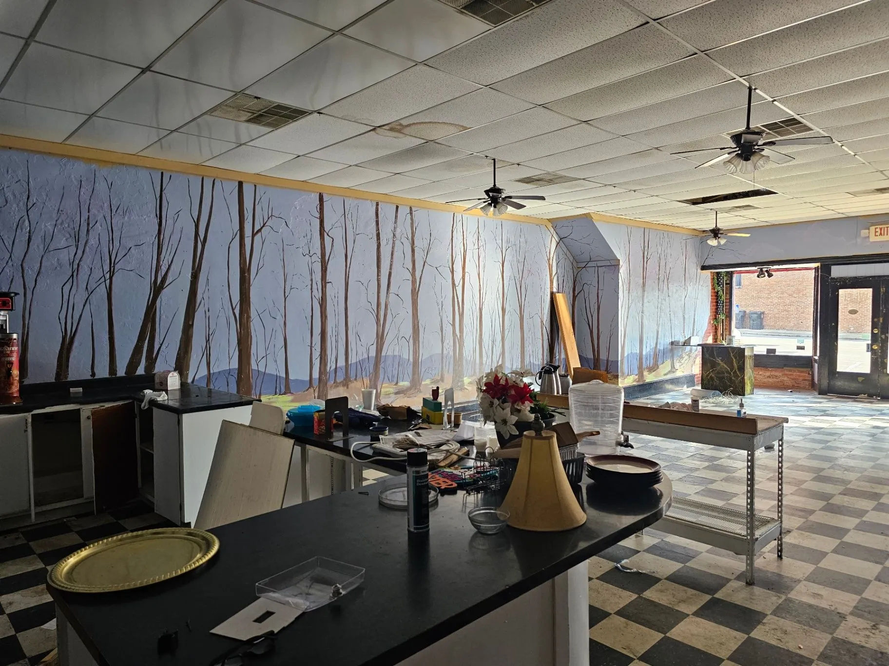 Wine Bar interior with mural walls, counters, and work tables during construction