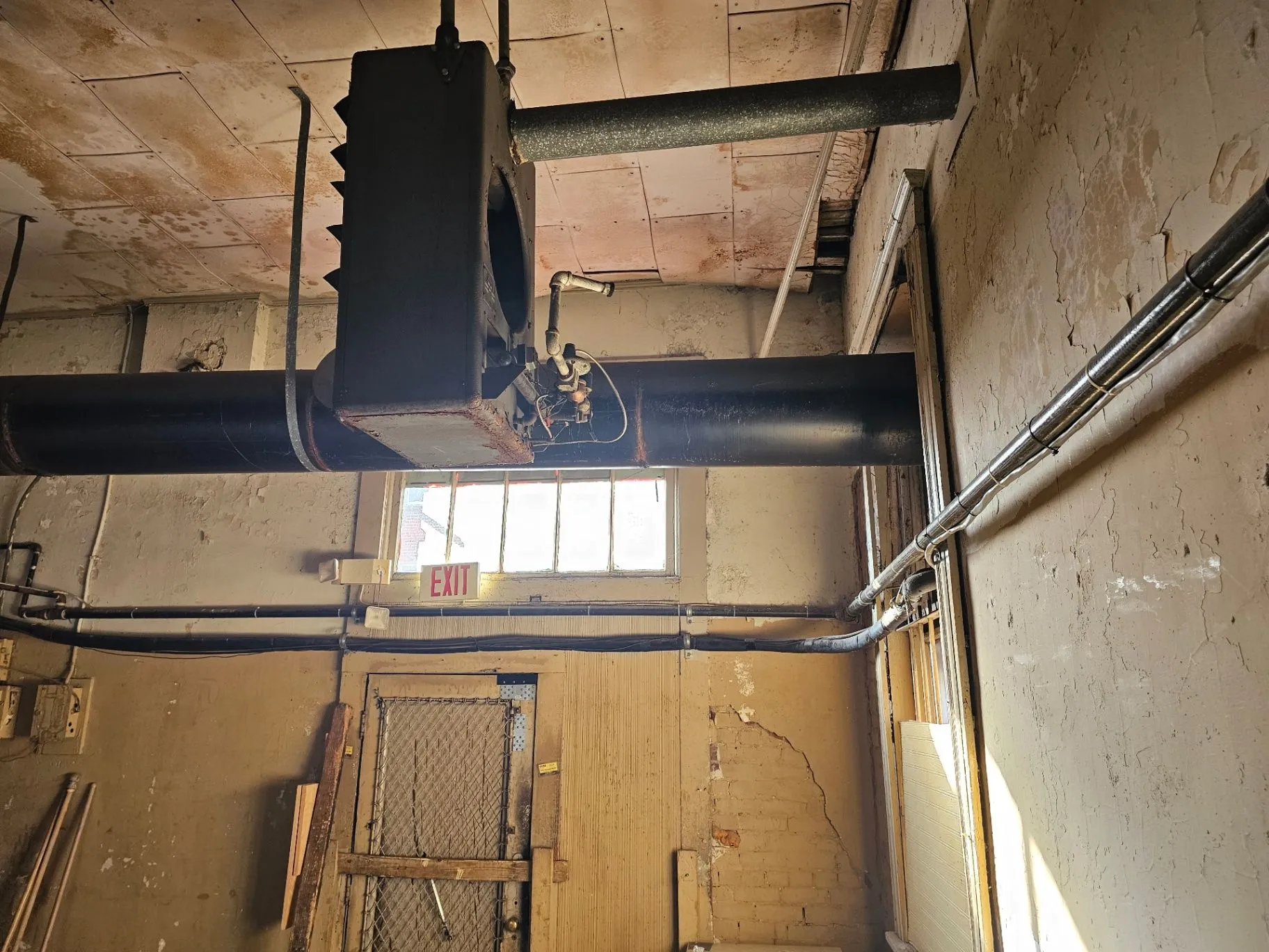 Exposed ductwork and unfinished ceiling in the Wine Bar space