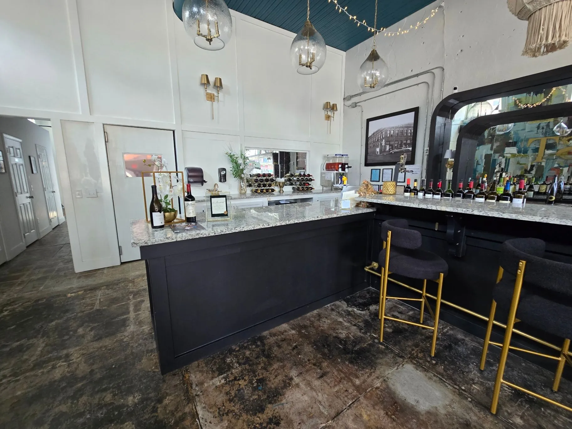 Completed Wine Bar service counter with wine storage, bottles, and black cabinetry